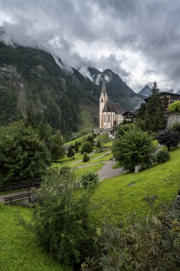 Parish church of St Vincent in Heiligenblut, cloudy mountain landscape, courtyard, Heiligenblut am