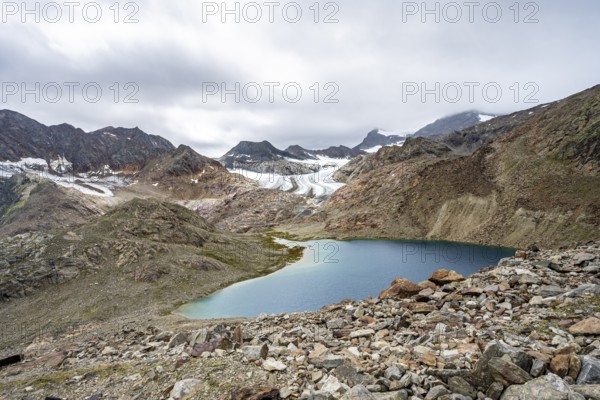 Mountain lake Vogelhüttensee, high mountain landscape with glacier Übeltalferner in the background,