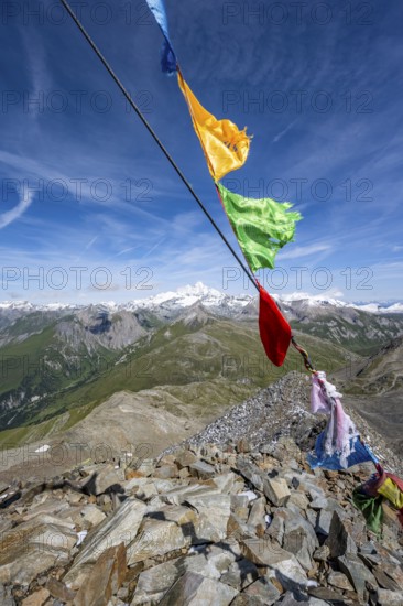 Böses Weibl summit with colourful prayer flags, view of picturesque mountain landscape with