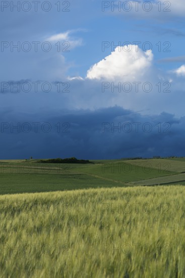 Dramatic cloudy sky with approaching storm and last rays of sunshine, Frankenhain, dark cloud wall,