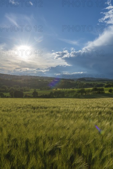 Dramatic cloudy sky with approaching storm and last sunbeams, Frankenhain, dark cloud wall, cumulus
