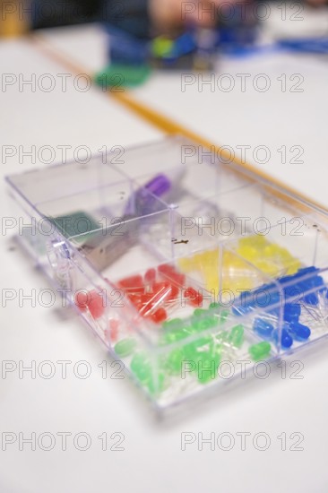 Colourful LEDs and electronic components in a plastic box on a table, Youth Research Centre Nagold,