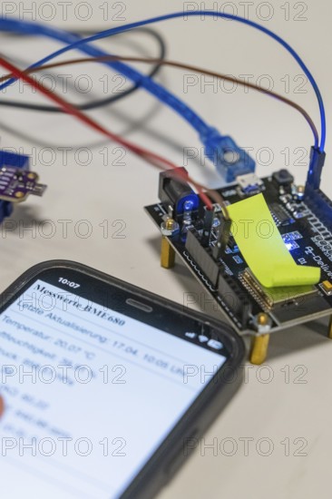 Close-up of a smartphone next to electronic components on a table, Nagold Youth Research Centre,