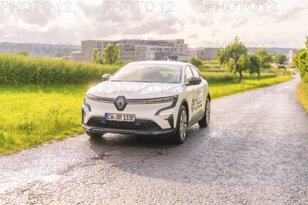 White Renault driving on a country road with the urban background, Renault Megane, Deer E