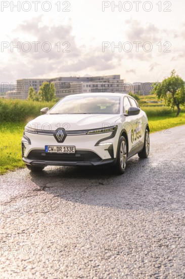 White Renault car on a road with fields and urban landscape in the background, Renault Megane, Deer