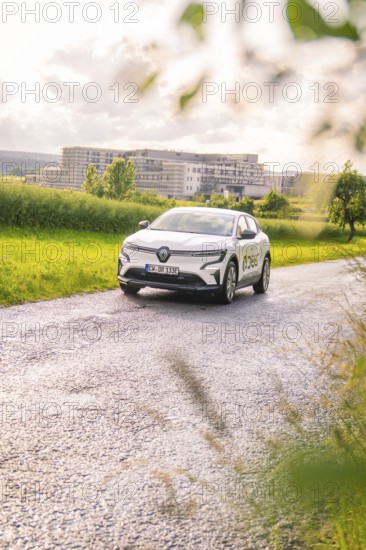 White Renault car on a rural road, surrounded by fields and trees, Renault Megane, Deer E