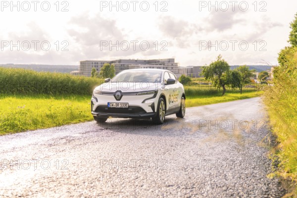 White Renault car driving along a tarmac road in a vast landscape, Renault Megane, Deer E