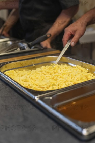 Fresh spaetzle is served in a tray at the buffet, Event and wedding location Kloster Lorch, Lorch,