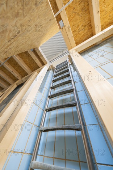View upwards along a ladder in a room with blue tiles, historical art exhibition in the old