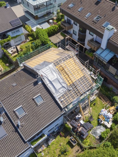 Aerial view of a house with roof under construction in suburban location, roof renovation, house