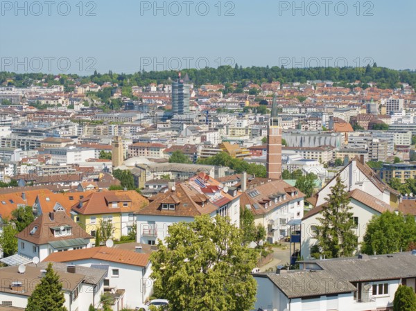 Bird's eye view of a town with various tiled roofs and a church tower, roof renovation, house