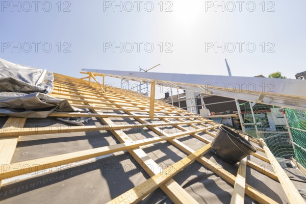 Wooden construction of a roof under construction in sunny weather, roof renovation, house