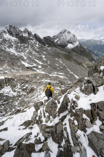 Mountaineer in rocky mountain landscape, at the summit of the Keeskopf, behind summit Kleiner