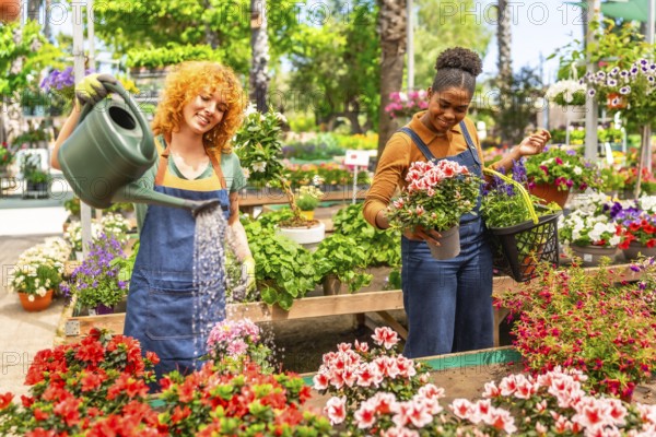 Two young women working together in a vibrant garden center, watering and arranging colorful potted