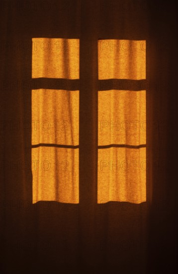 Interior view of a window with red curtain
