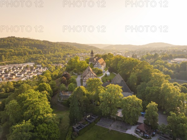 Aerial view of a village with half-timbered houses and church in hilly surroundings, event and