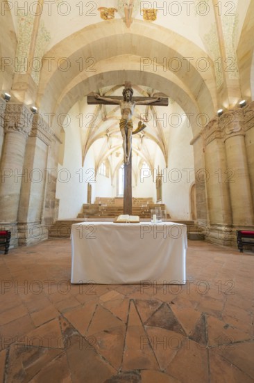 Altar with crucifix in a sacred room with stone arches, event and wedding location Lorch Monastery,