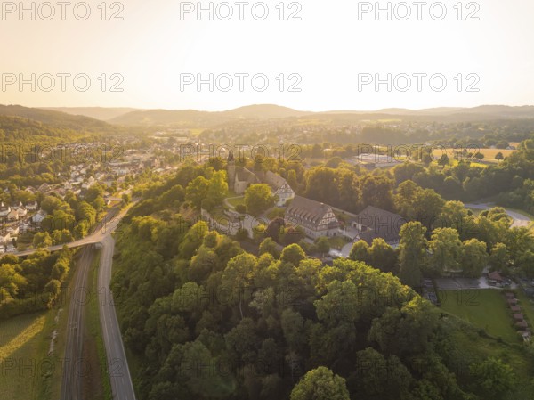 A village on a hill surrounded by forest and half-timbered houses at dusk, event and wedding