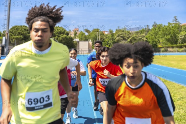 Diverse athletes competing fiercely on a vibrant blue track, pushing their limits and striving for