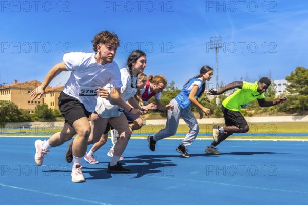 Diverse group of athletes sprinting on a vibrant blue running track under a bright sun, showcasing