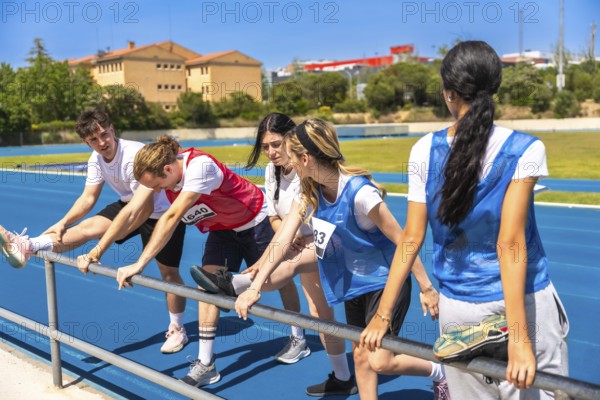 Runners stretching their legs on a vibrant blue track, preparing for a race while enjoying the