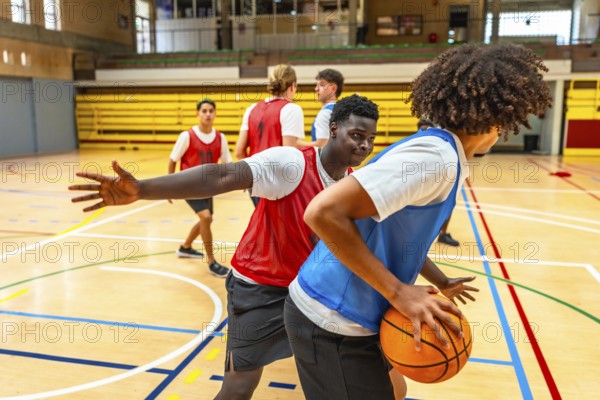 Two basketball players competing for the ball during a training match, showing sportsmanship and