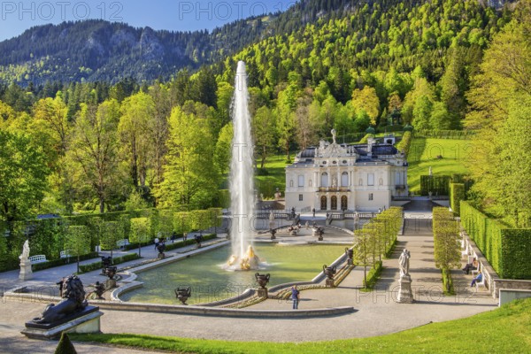 Water parterre with large fountain and portal of Linderhof Castle in spring, municipality of Ettal,