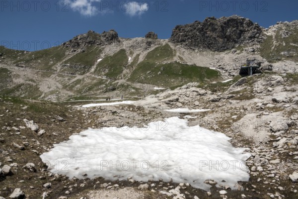 Remnant of snow and view of the Hintersteiner via ferrata, Nebelhorn, Oberstdorf, Allgäu Alps,