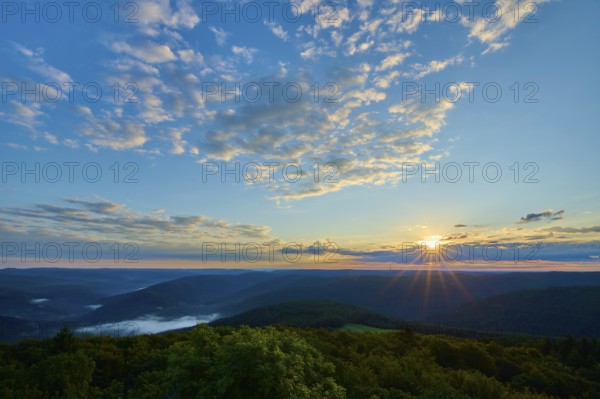 Sunrise over wooded hills, sky with light clouds and warm morning light, Katzenbuckel, Waldbrunn,