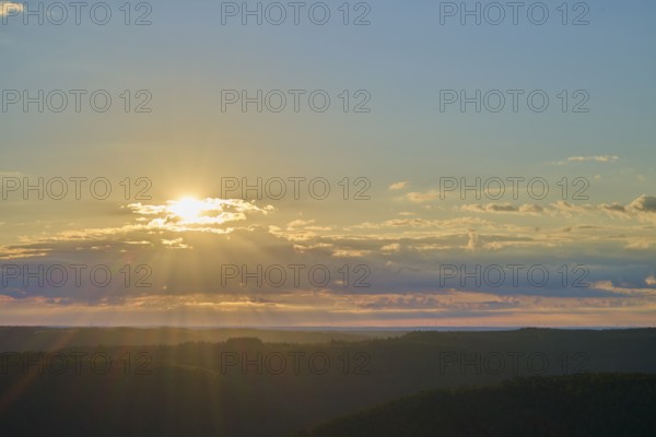 Sunrise over a calm landscape with clouds and rays of light, Katzenbuckel, Waldbrunn,