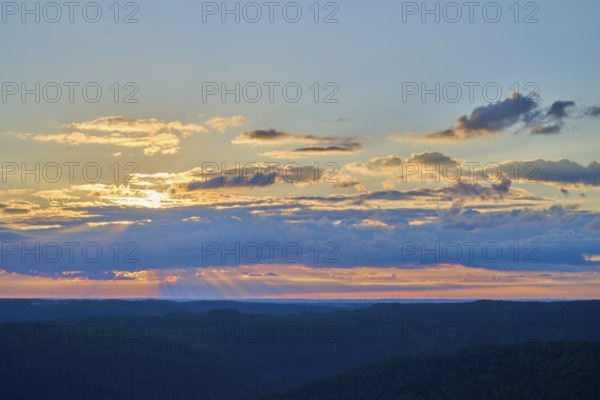Morning sky with coloured clouds and rays of light over the landscape, Katzenbuckel, Waldbrunn,