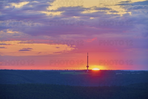Colourful sunrise with silhouette of a transmitter mast, transmitter Reisenbach, at dusk, seen from