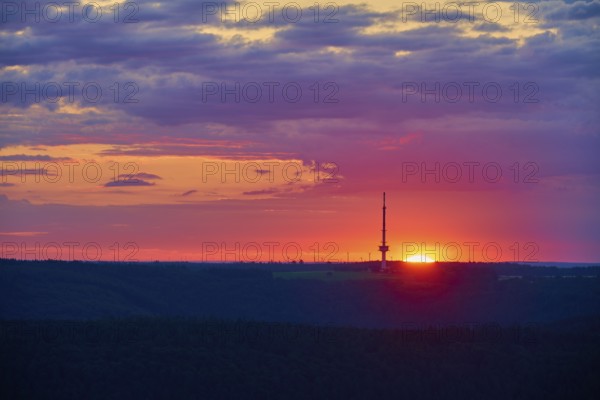 A bright sunrise with a prominent transmitter mast, Reisenbach transmitter, seen from the