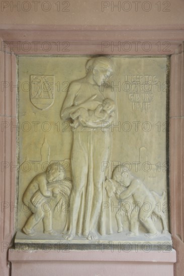 Relief in the inner courtyard of the town hall with inscription Give us today our daily bread,