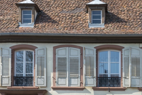 Facade of an old house with shingle roof and shutters, Wissembourg, Alsace, France
