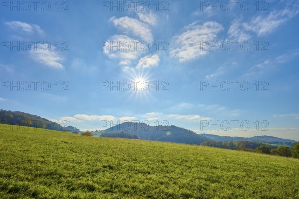 Wide meadow landscape under a bright sun and blue sky, Vöckelsbach, Mörlenbach, Bergstrasse