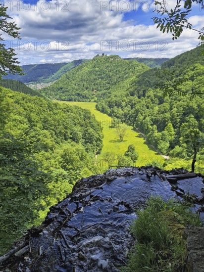 View from a hill onto a green valley (corn valley) with meadows, surrounded by wooded hills, Bad