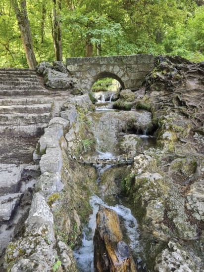 A small stone bridge over the Brühlbach, wild and romantic stream and source of the Urach waterfall