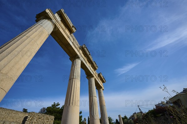 Upward view of ancient columns against the blue sky, Archaeological Site, Xysto Columned Hall,