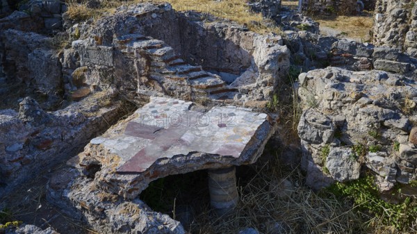 Detail of an ancient ruined site with stone structures and small staircase, Archaeological site,