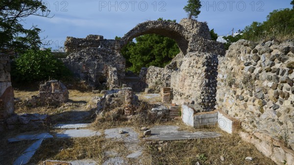 Ruins of an ancient site with stone arches and overgrown walls, Archaeological site, Western