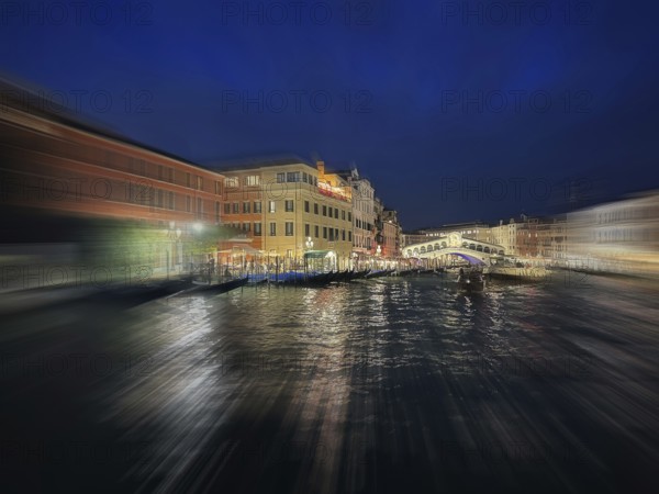 Gondolas on the Grand Canal, behind Rialto Bridge, night shot, zoom effect, lagoon city Venice,