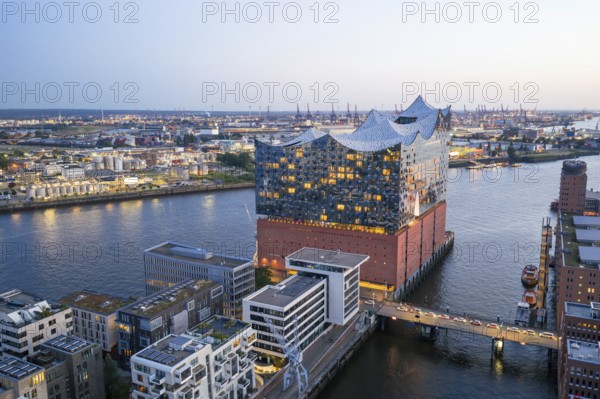 Aerial view of the Elbphilharmonie at blue hour with harbour and Elbe in the background, Hamburg,