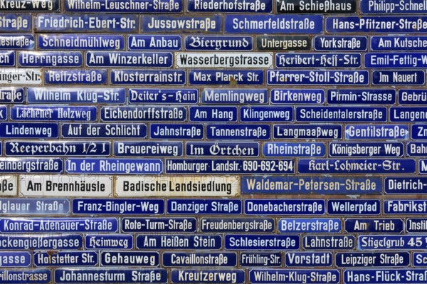 Dense collection of blue street signs with various street names, Amorbach, Odenwald, Bavaria,