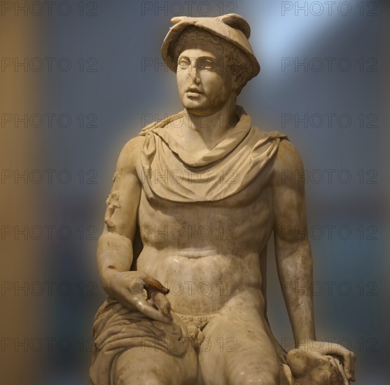 Seated marble sculpture of a man with ancient attributes such as a hat, god Hermes, classical