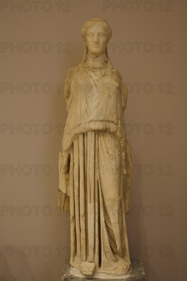 Marble sculpture of an ancient woman in elegant garb, presented in the museum, Archaeological