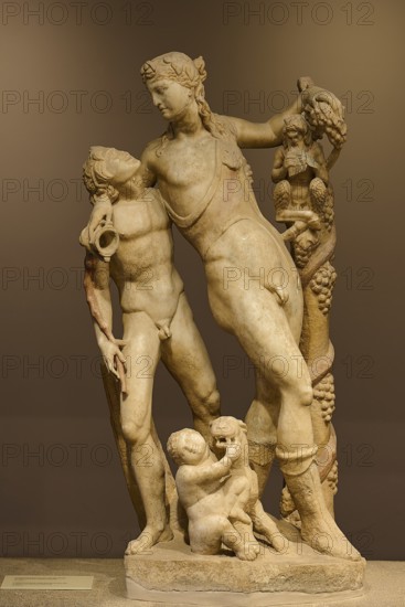 Ancient marble sculpture depicting several figures, including children and adults, satyr and Pan,
