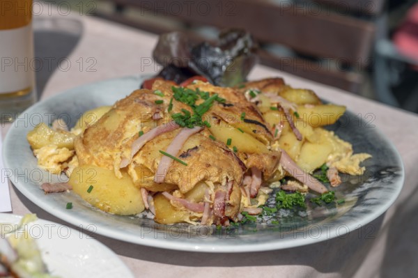 Omlett with fried potatoes served in a beer garden, Bavaria, Germany