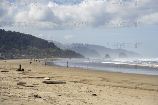 Sunny beach with large rocks in the sea and clear blue sky, peaceful and relaxing atmosphere,