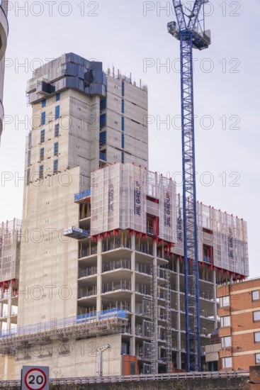 Large construction project with crane and building scaffolding in an urban area, London, United